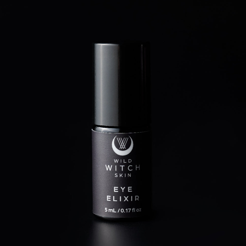 A 5 mL bottle of Wild Witch Skin Eye Elixir with a matte black cap and a dark black label, centered against a solid black background.